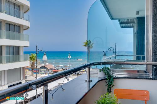 a balcony with a view of the beach at Dios Ponte 102 Beachfront in Larnaca