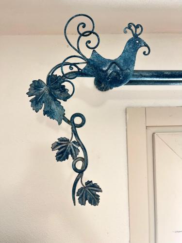 a metal decoration of a bird hanging on a door at Note Sulla Piazza in Cagliari