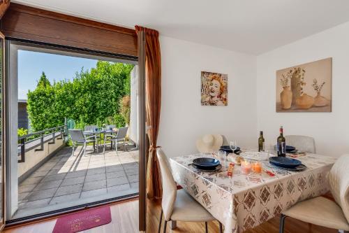 a dining room with a table and a balcony at Vernate Lugano Lake Sweet View - Happy Rentals in Vernate