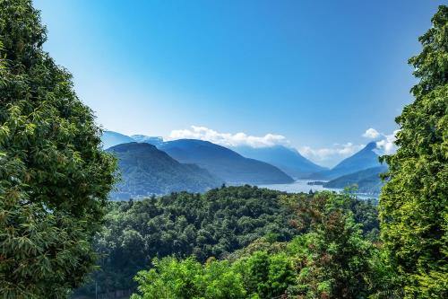 a view of a valley with mountains and a lake at Vernate Lugano Lake Sweet View - Happy Rentals in Vernate