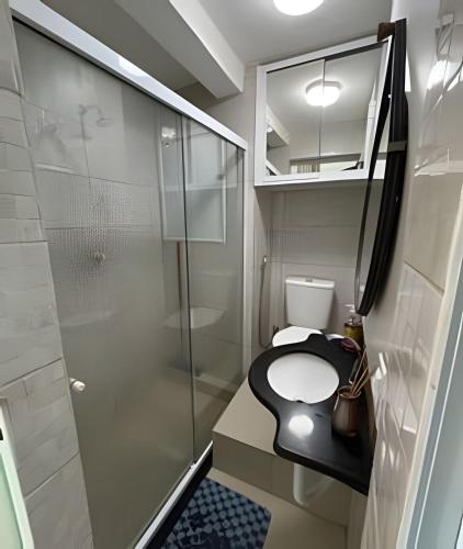 a small bathroom with a toilet and a shower at Flat praia a beira-mar in Natal
