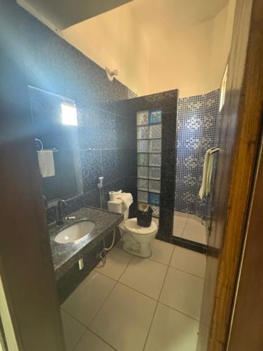 a bathroom with a toilet and a sink and a shower at Hotel beleléus Jericoacoara in Jericoacoara