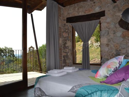 a bedroom with a large bed and a balcony at Belvilla by OYO Cobert de l'Era in Oden