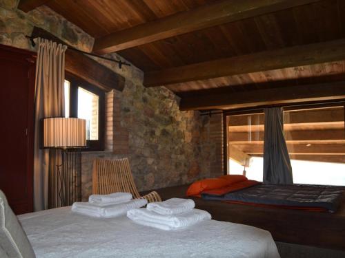 a bedroom with a bed with towels on it at Belvilla by OYO Cobert de l'Era in Oden