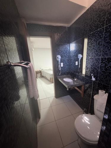 a bathroom with a toilet and a sink at Hotel beleléus Jericoacoara in Jericoacoara