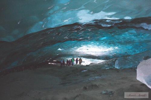 a group of people standing inside of an ice cave at Juneau Hideaway-Glaciers-5 min to downtown- Hiking in Juneau