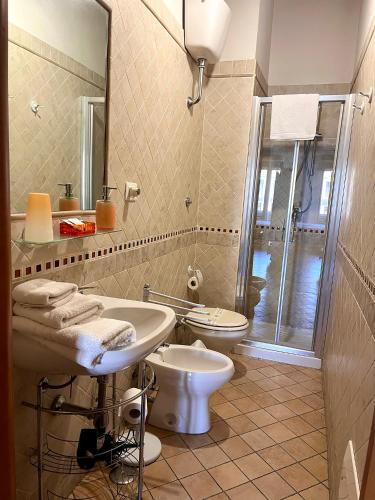 a bathroom with a sink and a toilet and a mirror at Note Sulla Piazza in Cagliari