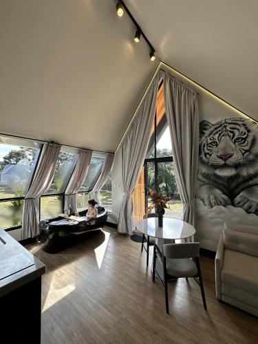 a room with a bed with a tiger on the wall at Morada Reino Encantado in São Joaquim