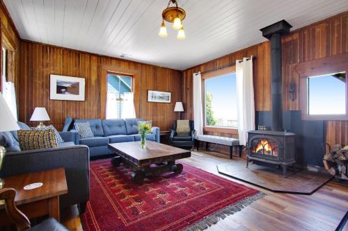 a living room with a couch and a fireplace at Headlands View Home in Mendocino