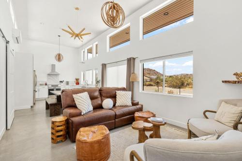 a living room with a couch and a table at Desert Contemporary Compound - Large Modern Oasis in Joshua Tree