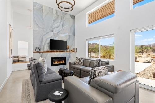 a living room with a couch and a fireplace at Desert Contemporary Compound - Large Modern Oasis in Joshua Tree