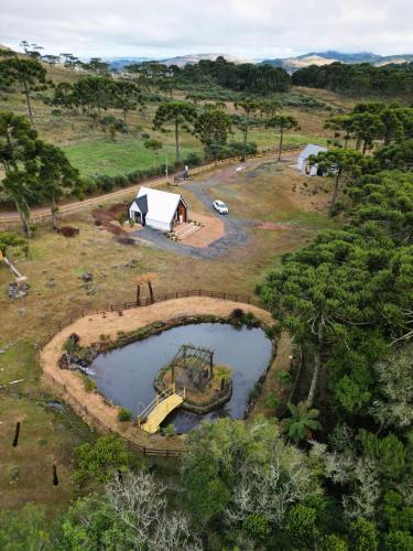 an aerial view of a camping site with a tent and a pond at Morada Reino Encantado in São Joaquim