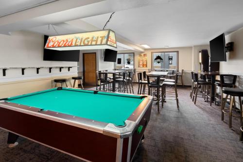 a pool table in a room with a bar at Fargo Inn and Suites in Fargo