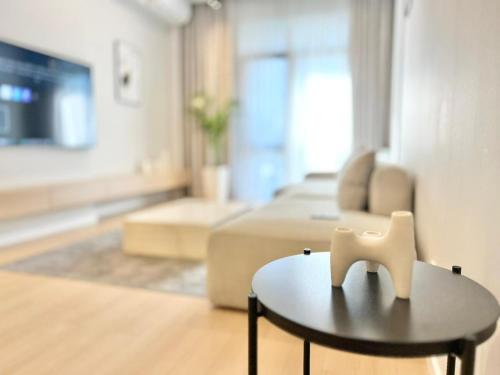 a living room with a couch and a coffee table at Luxury apartment Saburtalo view in Tbilisi City