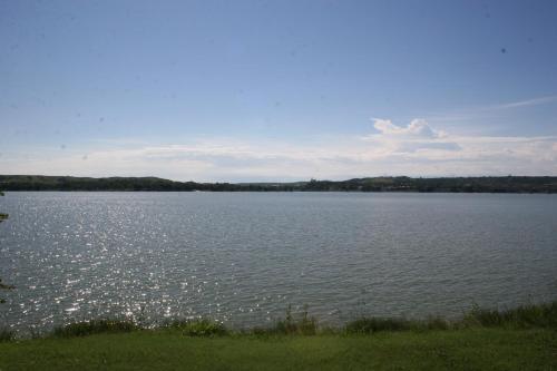 a large body of water with trees in the background at Cedar Shore Resort in Oacoma
