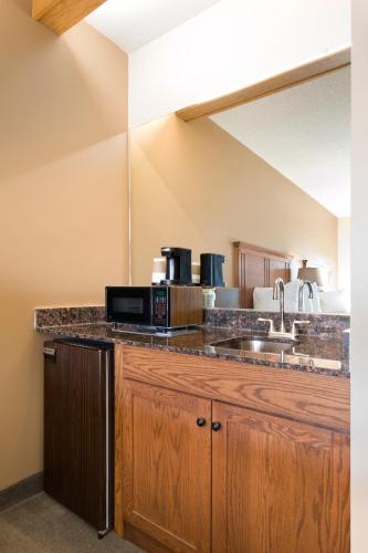 a kitchen with a sink and a microwave at Cedar Shore Resort in Oacoma