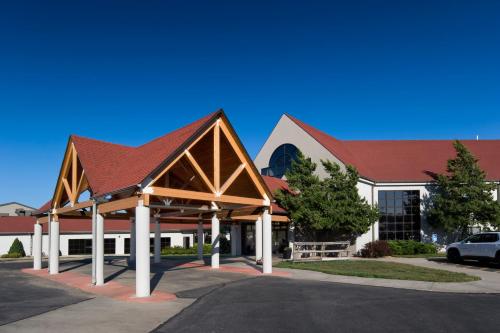 a large building with a red roof and a parking lot at Cedar Shore Resort in Oacoma