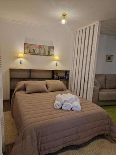 a bedroom with a bed with two towels on it at La Casona in Redondela
