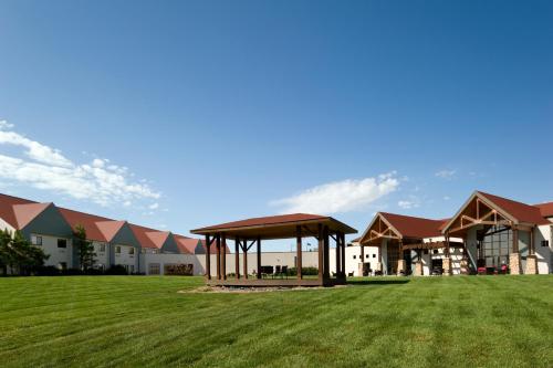 a large building with a gazebo in a field at Cedar Shore Resort in Oacoma