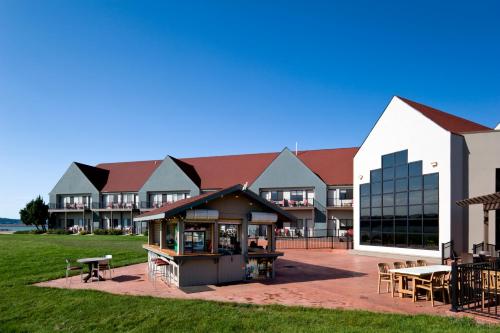 a building with a table and chairs in front of it at Cedar Shore Resort in Oacoma