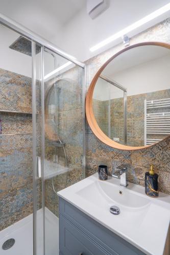 a bathroom with a sink and a mirror at Sunshine Resort Blue Apartman in Zamárdi