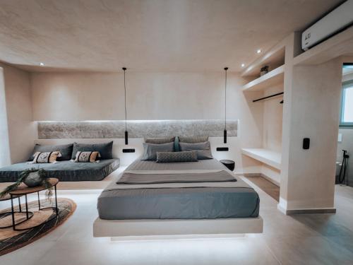 a large bedroom with two beds in it at Nonna's Suites in Naxos Chora