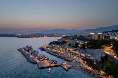 an aerial view of a resort on the water at night at Le Meridien Lav Split in Podstrana