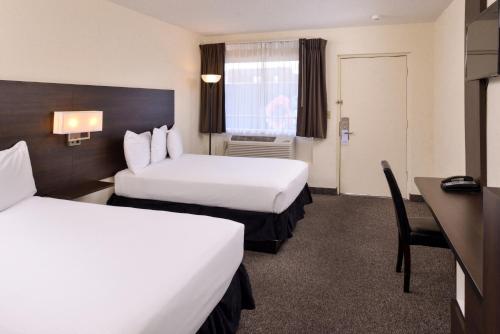 a hotel room with two beds and a desk at Steam Plant Hotel in Spokane