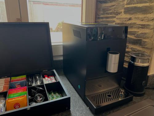 a small black refrigerator next to a tv at Mosel Winzerhaus an der Lieser - Sonnenterrasse, Weinberge & Nähe Bernkastel-Kues in Maring-Noviand