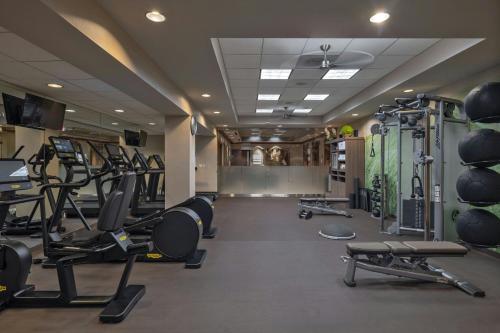a gym with several treadmills and lots of machines at The Westin Houston Downtown in Houston