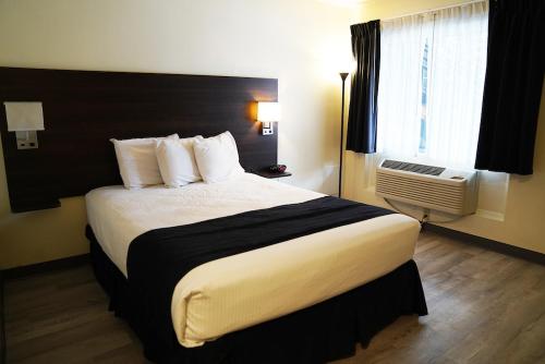 a hotel room with a large bed and a window at Steam Plant Hotel in Spokane