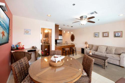 a living room with a table and a couch at Morritt's Tortuga Club 1 BR LUXE Condo Sleeps 4 in Sand Bluff