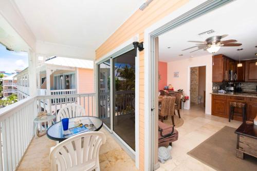 a room with a balcony with a table and chairs at Morritt's Tortuga Club 1 BR LUXE Condo Sleeps 4 in Sand Bluff