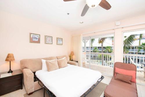 a bedroom with a bed and a couch at Morritt's Tortuga Club 1 BR LUXE Condo Sleeps 4 in Sand Bluff