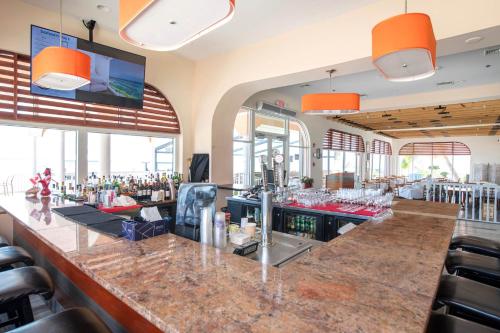 a bar in a restaurant with orange lights at Morritt's Tortuga Club 1 BR LUXE Condo Sleeps 4 in Sand Bluff