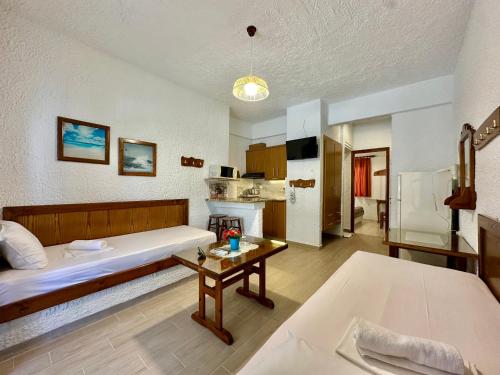 a room with a bed and a table in it at Haus Niko Apartments and Suites in Nea Potidaea