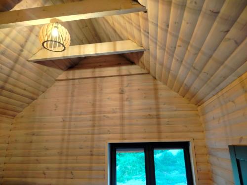 a ceiling in a log cabin with a light at Zapach Lasu Polanica -Zdrój 
