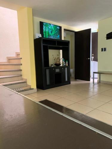 a living room with a flat screen tv on a wall at Hermosa casa residencial alberca propia climatizada in Cuautla Morelos