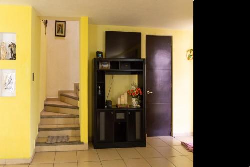 a hallway with a door and aoyer with a staircase at Hermosa casa residencial alberca propia climatizada in Cuautla Morelos