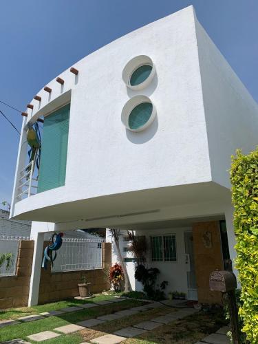 a white house with the number eight on it at Hermosa casa residencial alberca propia climatizada in Cuautla Morelos