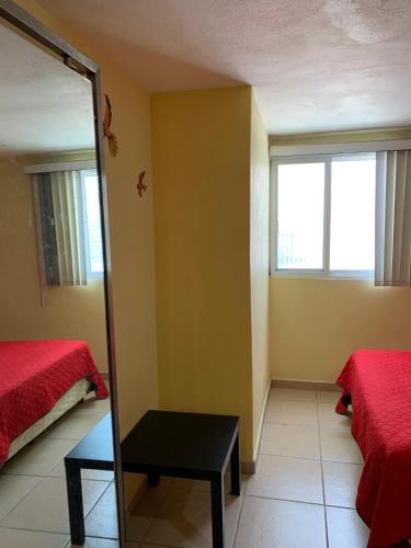 a room with two beds and a mirror at Hermosa casa residencial alberca propia climatizada in Cuautla Morelos