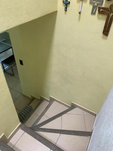 a view of a hallway with a cross on the wall at Hermosa casa residencial alberca propia climatizada in Cuautla Morelos