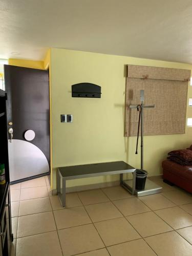 a room with a bench in the corner of a room at Hermosa casa residencial alberca propia climatizada in Cuautla Morelos