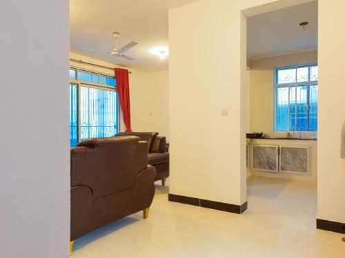 a living room with a couch and a chair at Spacious Beachfront Condo -AC - WiFi, Uroa Escape Zanzibar in Uroa
