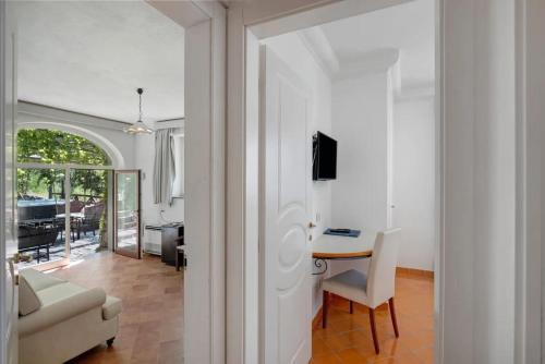 a living room with a table and a couch at Luxury Villa Seaview con jacuzzi in Conca dei Marini