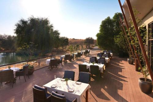 a restaurant with tables and chairs on a patio at The Ritz-Carlton Ras Al Khaimah, Al Wadi Desert in Ras al Khaimah
