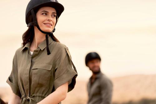 a woman wearing a helmet and a headset at The Ritz-Carlton Ras Al Khaimah, Al Wadi Desert in Ras al Khaimah