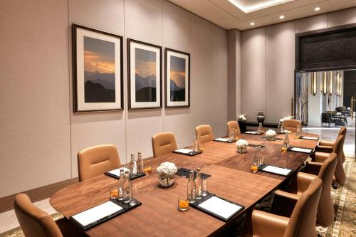 a conference room with a large wooden table and chairs at The Ritz-Carlton Ras Al Khaimah, Al Wadi Desert in Ras al Khaimah