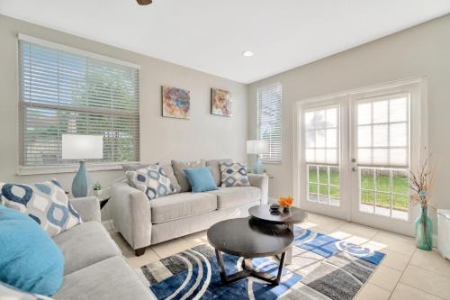 a living room with a couch and a table at Spacious House with big backyard in N. Hyde Park / Close to Downtown in Tampa
