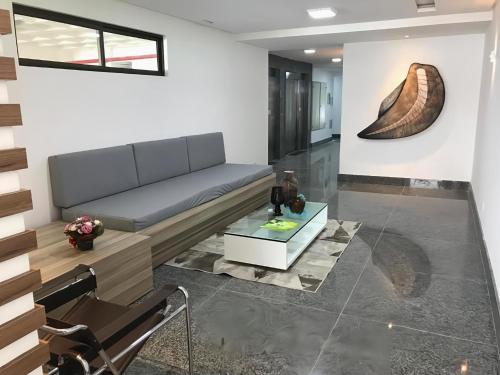 a living room with a couch and a table at Flats Mobiliados Zona Norte, Casa Forte e Recife in Recife